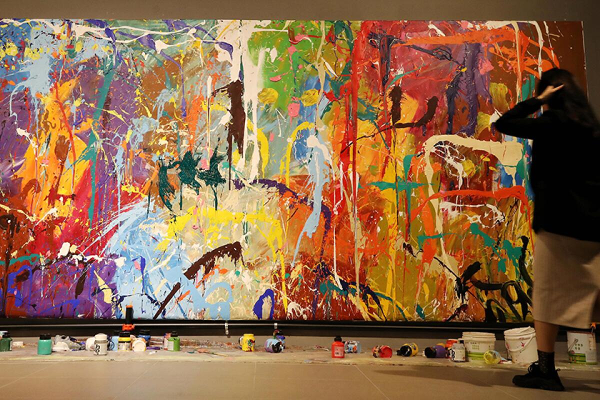 A large canvas with paint splattered over it