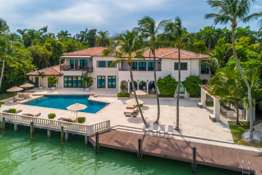 The 12,000-square-foot residence comes with a basketball court, playground, cabana, pool and private dock overlooking Biscayne Bay.