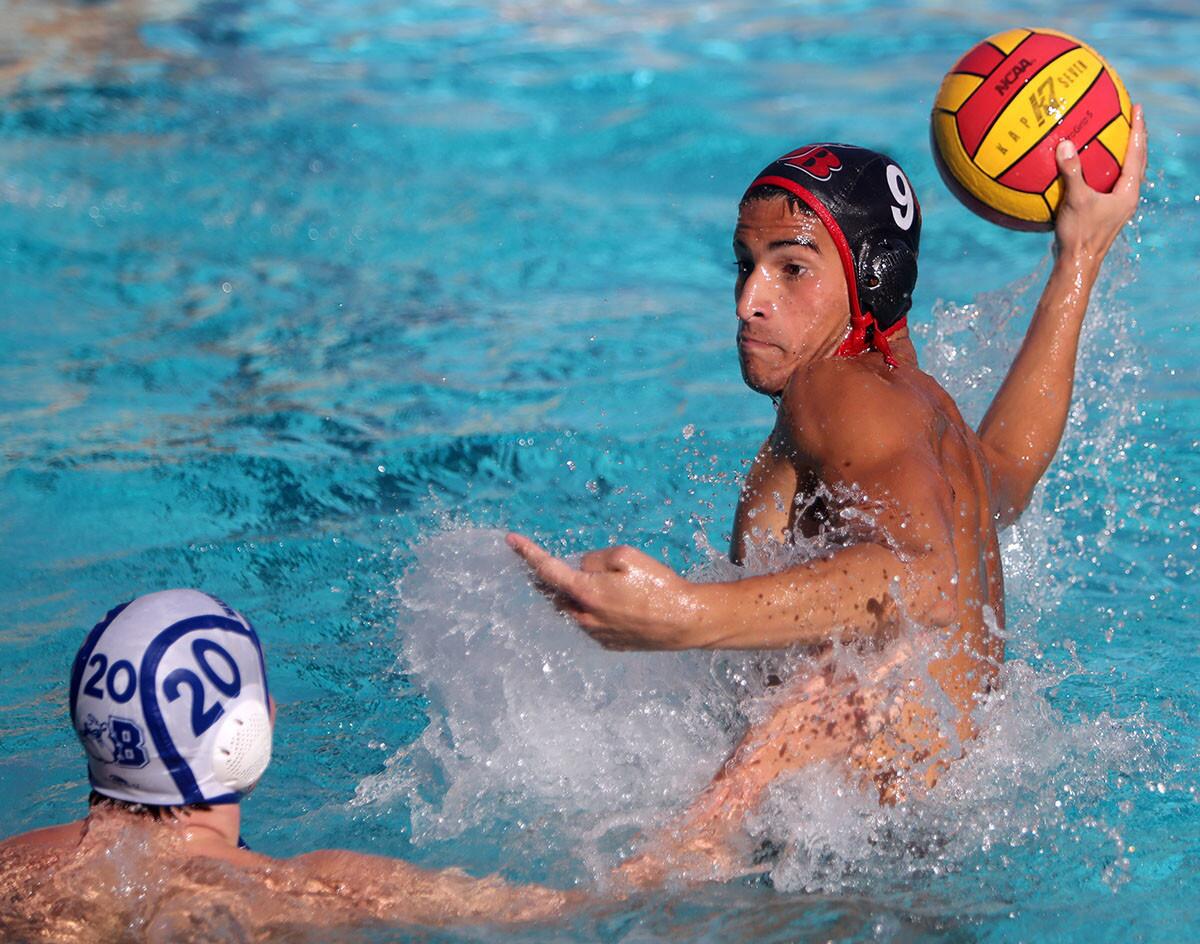 Burroughs High School boys water polo player #9 Chase Legorreta takes a shot on goal under pressure from player #20 Roll Ford in home game vs. Burbank High School in Burbank on Thursday, Oct ,18, 2018.