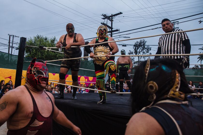 Black Mamba, Inframundo Jr., and Commando I during a match at the Baja Stars USA Lucha Libre event at the Mujeres Brew House in Barrio Logan on August 21, 2021.