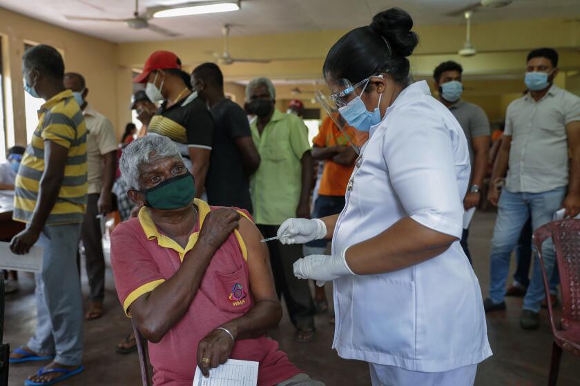 A Sri Lankan nurse administers COVID-19 vaccine to a municipal worker in Colombo, Sri Lanka, Tuesday, Feb. 16, 2021. (AP Photo/Eranga Jayawardena)
