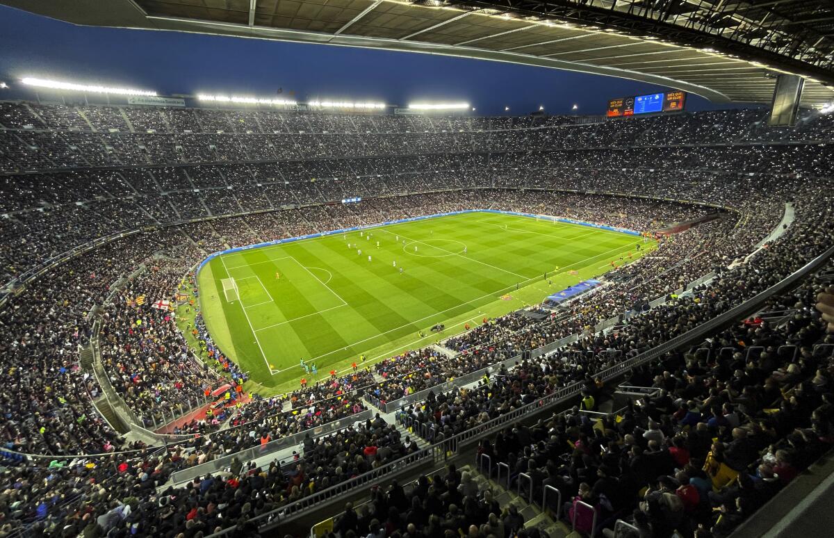 Spectators crowd the Camp Nou stadium during the Women's Champions League quarterfinal, second leg soccer match between Barcelona and Real Madrid in Barcelona, Spain, Wednesday, March 30, 2022. A world-record crowd for a women's soccer match of more than 91,000 people watched Barcelona defeat Real Madrid 5-2 in the Champions League at the Camp Nou Stadium. (AP Photo/Maria Angela Angles)