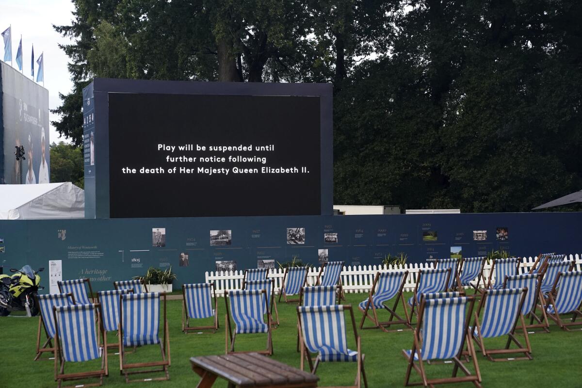 A screen displays a message that play has been suspended on day one of the PGA Championship at Wentworth Golf Club, Virginia Water, England, Thursday Sept. 8, 2022, following the announcement of the death of Britain's Queen Elizabeth II. (Adam Davy/PA via AP)