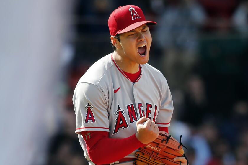 Los Angeles Angels' Shohei Ohtani reacts after striking out Boston Red Sox's Trevor Story.