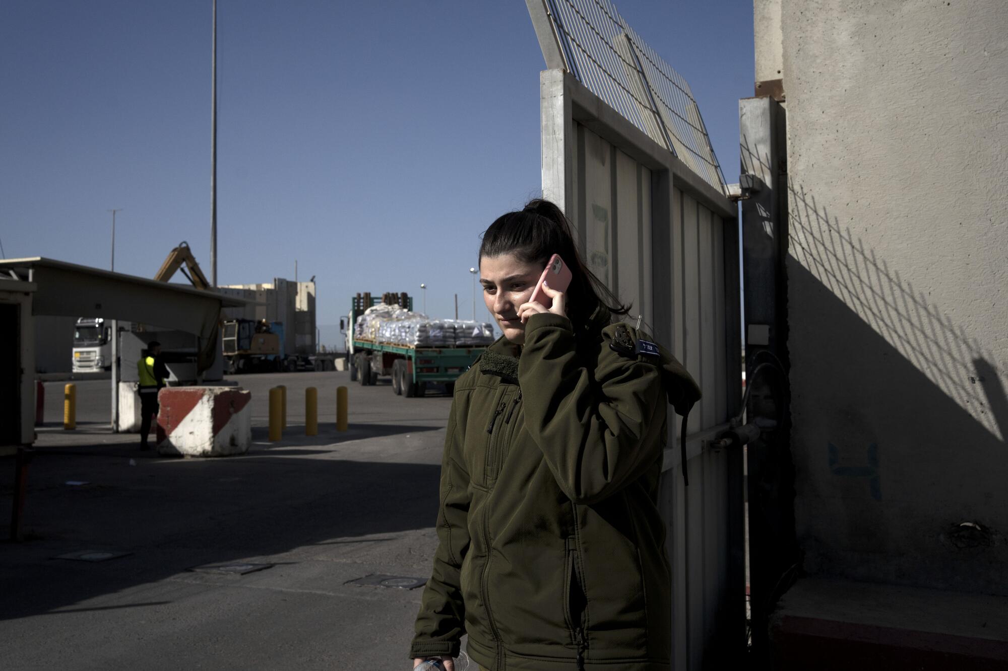 Israeli soldier on her phone at Israel-Gaza border
