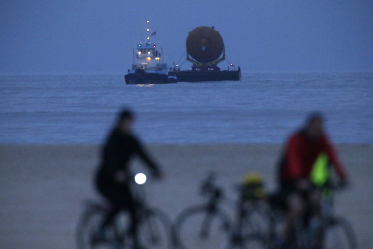 ET-94, NASA's last remaining space shuttle external tank, approaches Marina del Rey, pulled by a tugboat Wednesday morning.