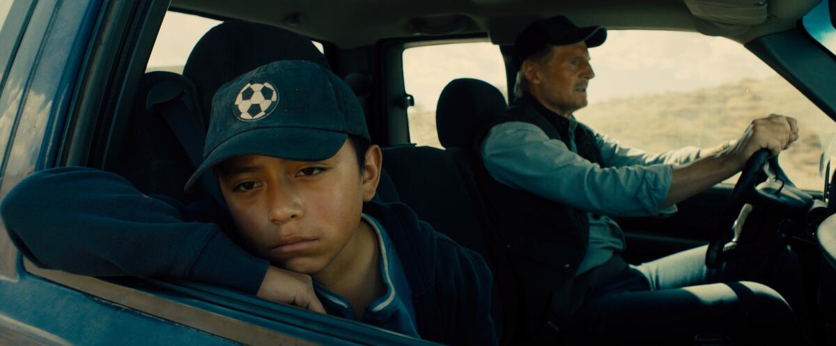 On the road (again) — Jacob Perez, left, and Liam Neeson are fleeing cops and cartel guys in "The Marksman."