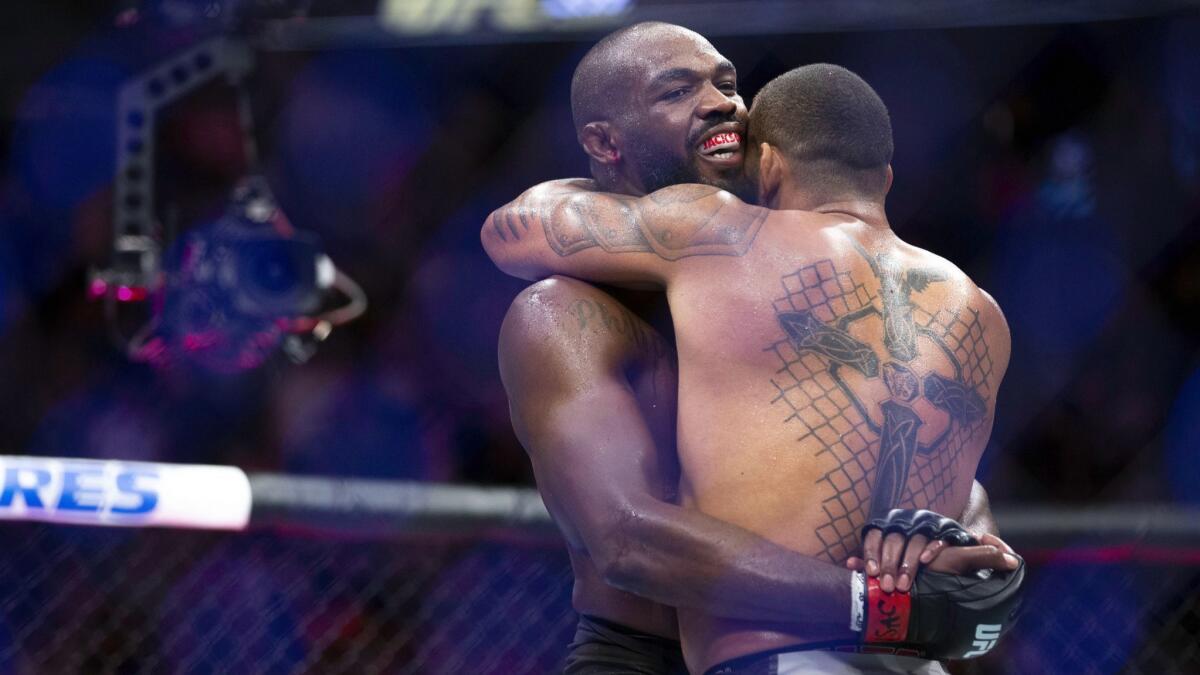 Jon Jones, left, and Thiago Santos embrace after their fight at T-Mobile Arena. Jones survived being taken the distance before claiming a split-decision victory.