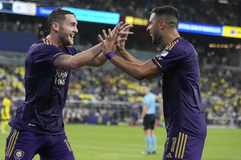 Orlando City forward Duncan McGuire, left, and midfielder Martín Ojeda, right, celebrate a goal against Nashville SC during the first half of an MLS soccer match Wednesday, Oct. 4, 2023, in Nashville, Tenn. (AP Photo/George Walker IV)