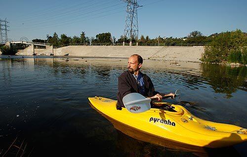 Humorist blogger George Wolfe navigates his kayak on the Los Angeles River in Los Feliz . Wolfe is a fervent believer in the navigability of the L.A. River and has written letters on behalf of environmental concerns about the river.