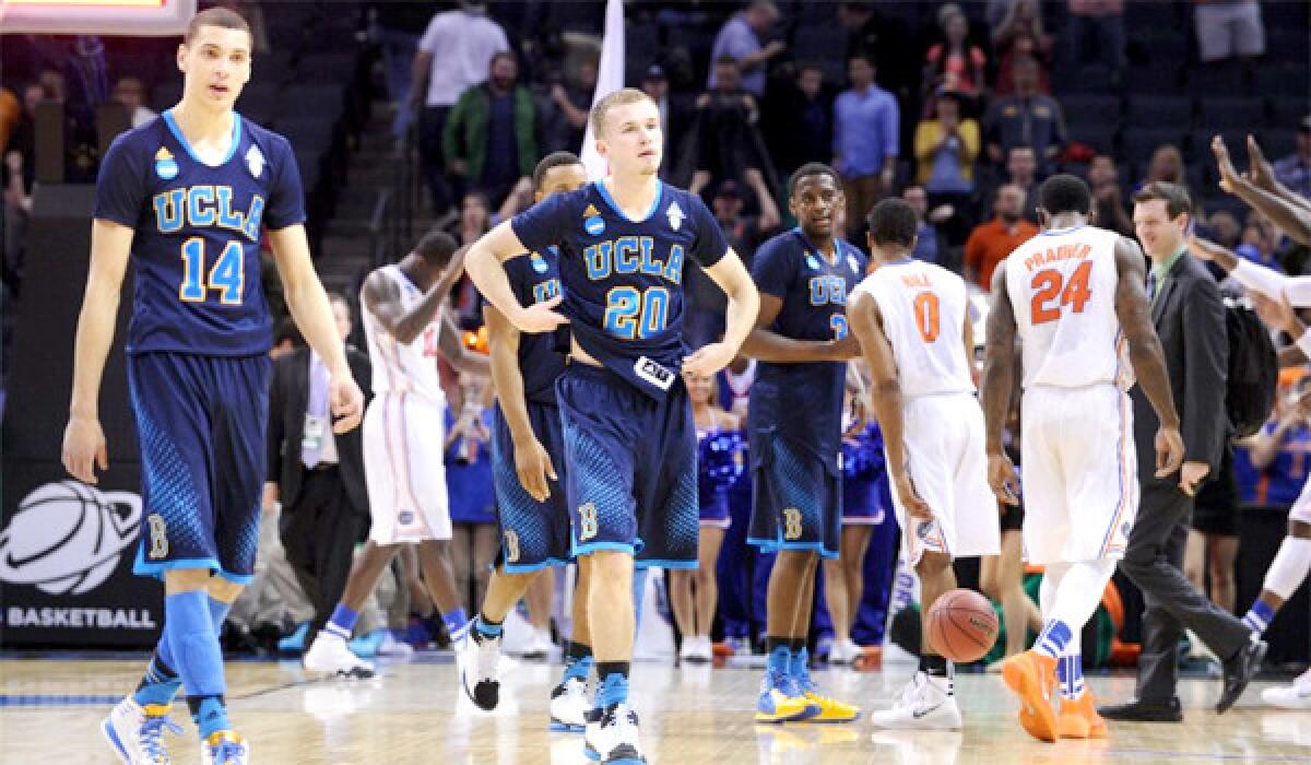 UCLA's Zack LaVine, left, and Bryce Alford, right, walk off the court after the Bruins' loss to Florida, 79-68, on Thursday in the Sweet 16 round of the NCAA tournament.