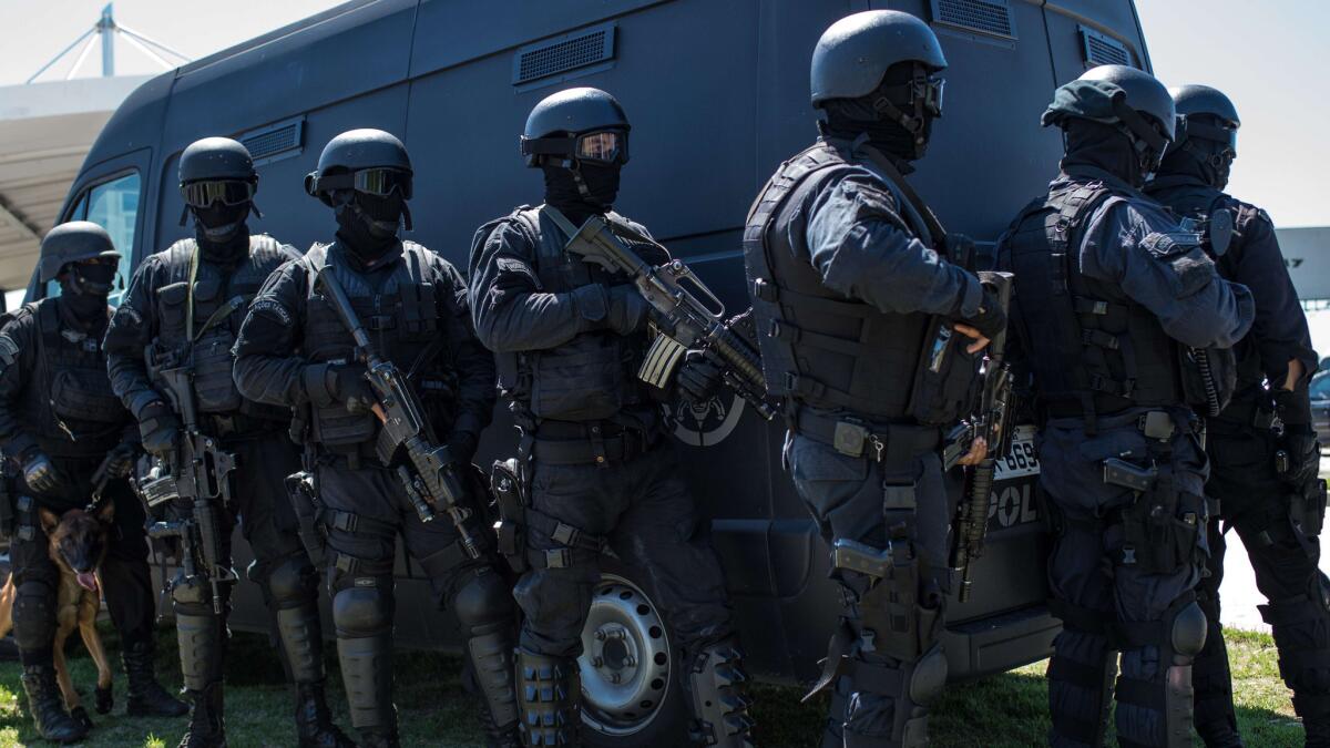 A Brazilian paramilitary police unit takes part in a hijacking simulation on Feb. 11 as part of the force's preparation for the 2016 Rio de Janeiro Olympic Games.