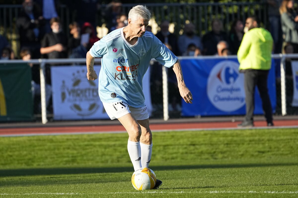 Former Arsenal manager Arsene Wenger plays during a charity soccer match Thursday, Oct. 14, 2021 at the Leo Lagrange stadium in Poissy, outside Paris. French President Emmanuel Macron also plays a charity soccer match to raise money for the Hospitals' Foundation, alongside former Arsenal manager Arsene Wenger. (AP Photo/Michel Euler)