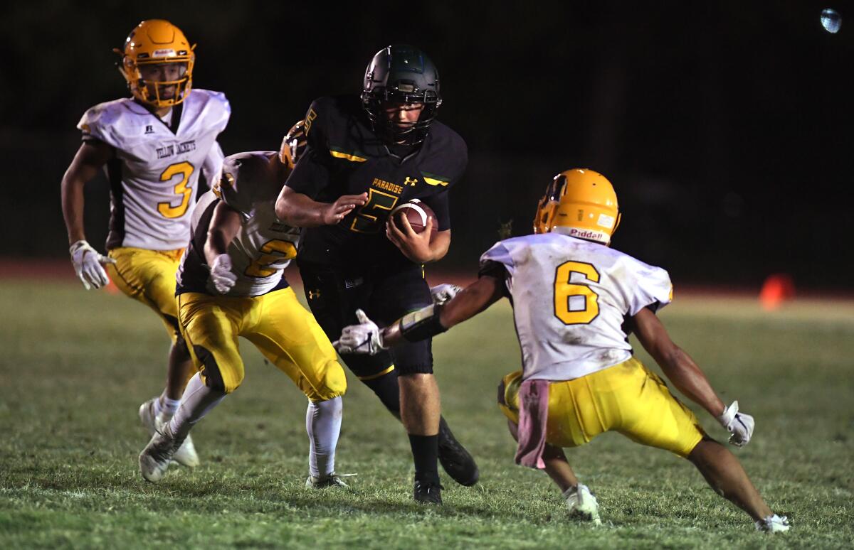 Paradise quarterback Danny Bettencourt carries the ball against Williams in August.
