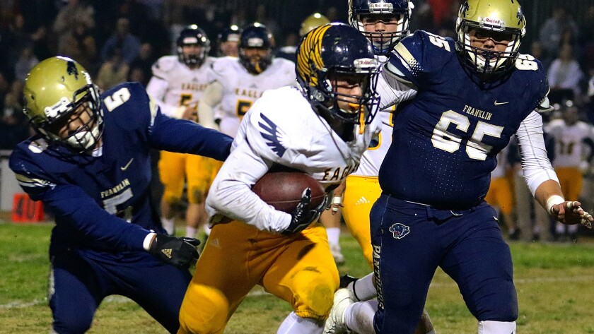 Franklin linebacker Daniel Rodriguez (left) tries to tackle Rancho Christian's Jalen Schieberl during their regional playoff game Friday night.
