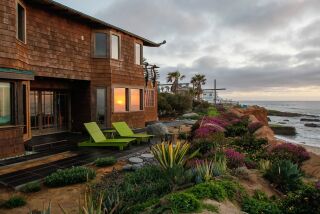 A sunset view of the 1913 Sunset Cliffs bungalow that recently underwent a major renovation.