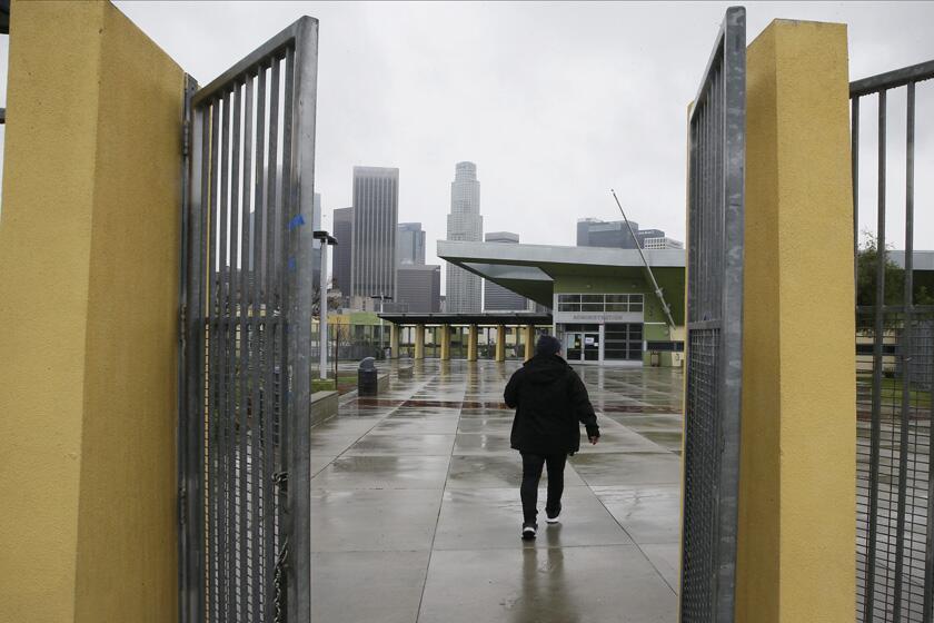 A parent arrives to pick up a student at the Edward R. Roybal Learning Center in Los Angeles after the district announced school closures in March.