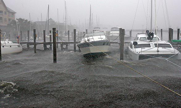 Boats docked along the waterfront rock in the wind and rain from Tropical Storm Hanna in Manteo, N.C., Saturday.