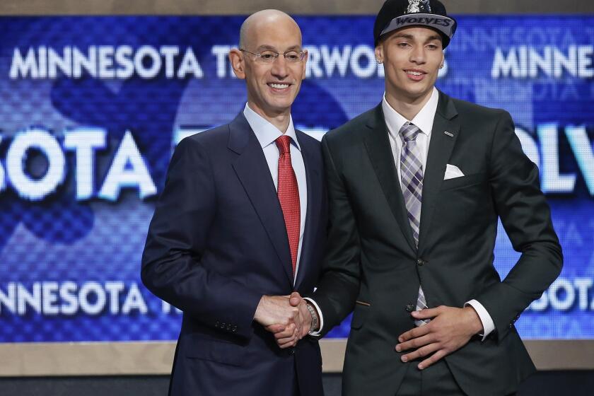 Zach LaVine shakes hands with NBA Commissioner Adam Silver after being selected with the 13th overall pick in the NBA draft by the Minnesota Timberwolves.