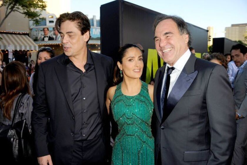 Actors Benicio Del Toro, left, Salma Hayek and director Oliver Stone arrive at the premiere of "Savages." Director Oliver Stone's "Savages" takes place in Laguna Beach, where young entrepreneurs Ben and Chon create a lucrative marijuana business. When Mexican drug cartel Baja Cartel asks for a partnership and is denied, kidnapping and violence follow. Click through the gallery to see photos from the premiere at Westwood Village.
