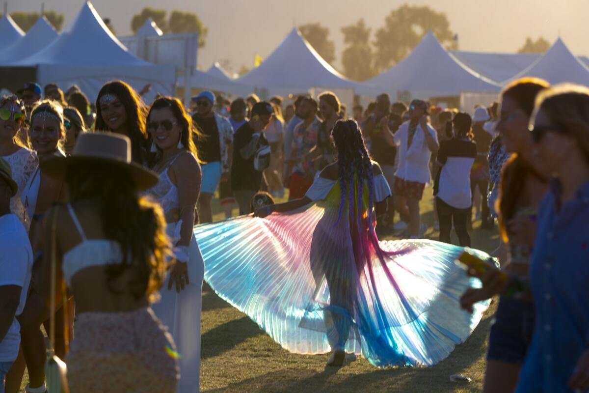 Festival goers head for late afternoon shows as the sun sets on Day 2 at the Coachella Valley Music and Arts Festival.