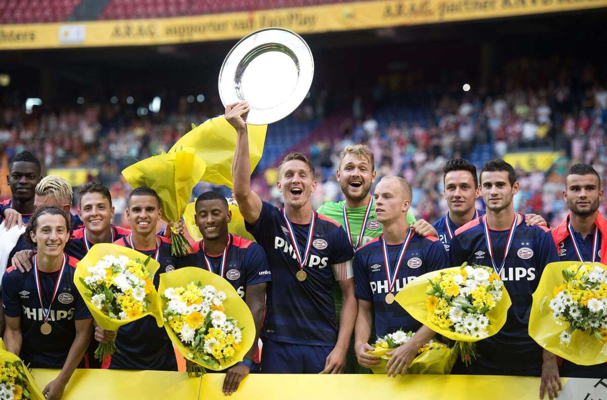 PSV Eindhoven's captain Luuk de Jong (C) shows the cup after winning the Dutch Super Cup football match between League champions Eindhoven and National Cup winner Groningen, in Amsterdam on August 2, 2015. AFP PHOTO / ANP / OLAF KRAAK == NETHERLANDS OUT == OLAF KRAAK/AFP/Getty Images ** OUTS - ELSENT, FPG - OUTS * NM, PH, VA if sourced by CT, LA or MoD **