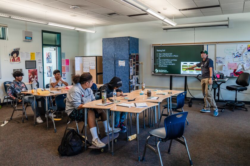Research Associate Connor Parks from the San Diego Zoo Wildlife Alliance speaks to students, Jesus Cortes, 14 years old, Dominique Orozco, 15 years old, Kaidon Mao, 15 years and Vale Rondero, 14 years old about soil testing at Lincoln High School on July 11, 2022.