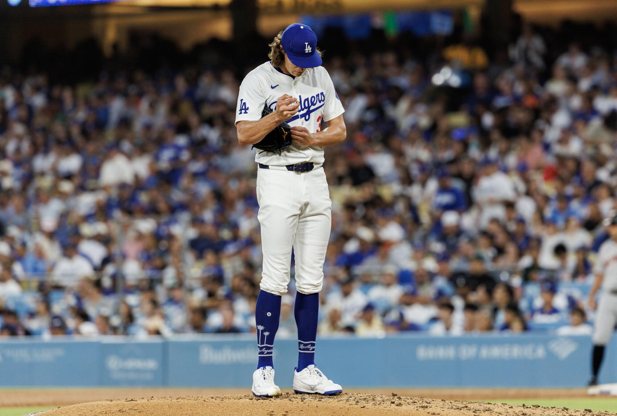 Dodgers pitcher Tyler Glasnow clutches the ball on the mound during a game against the Giants on July 24 at Dodger Stadium.