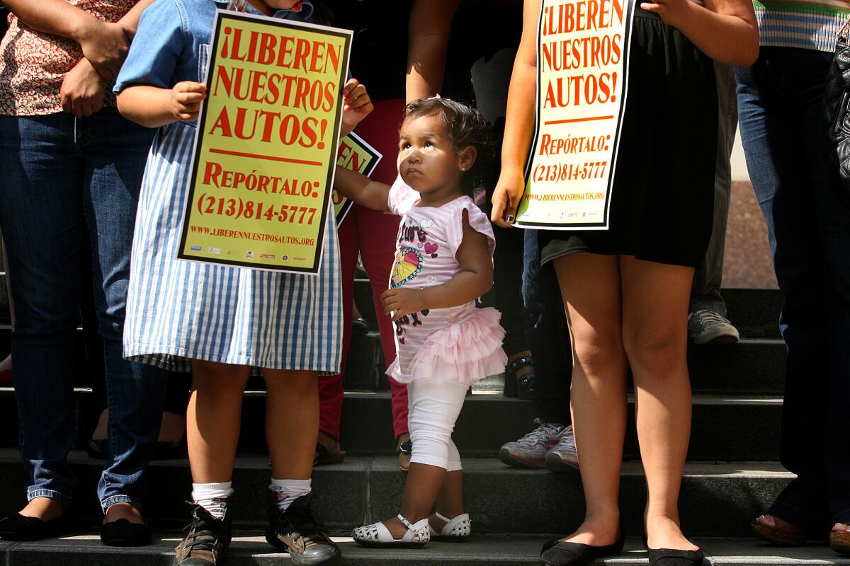 Twenty-month-old Yaretzie Vasquez of Baldwin Park attends a news conference Wednesday outside the Los Angeles County Hall of Administration with her mother and sister. The Free Our Cars Coalition announced a campaign to change towing and impound practices that it says hurt immigrant families.