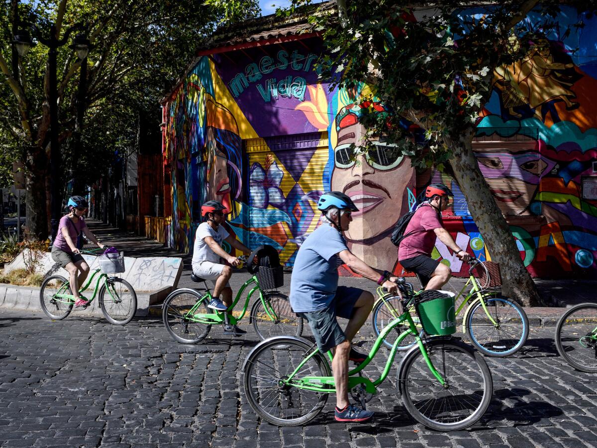 A group of tourist ride their rent bicycles in Bellavista neighborhood in Santiago, Chile.