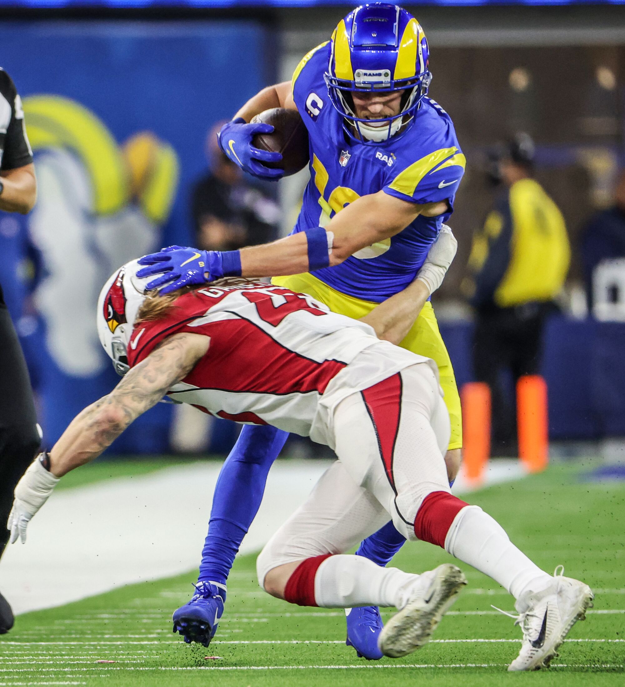 Rams wide receiver Cooper Kupp sheds a tackle by Cardinals linebacker Dennis Gardeck.