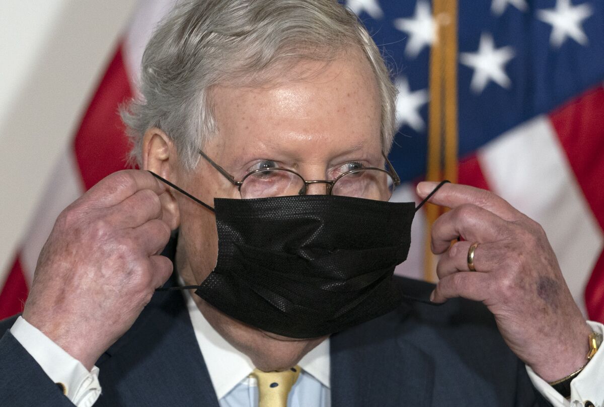 Senate Majority Leader Mitch McConnell of Ky., puts his face mask back on after speaking during a news conference of Senate Republican leadership, Wednesday, Sept. 9, 2020, on Capitol Hill in Washington. (AP Photo/Jacquelyn Martin)