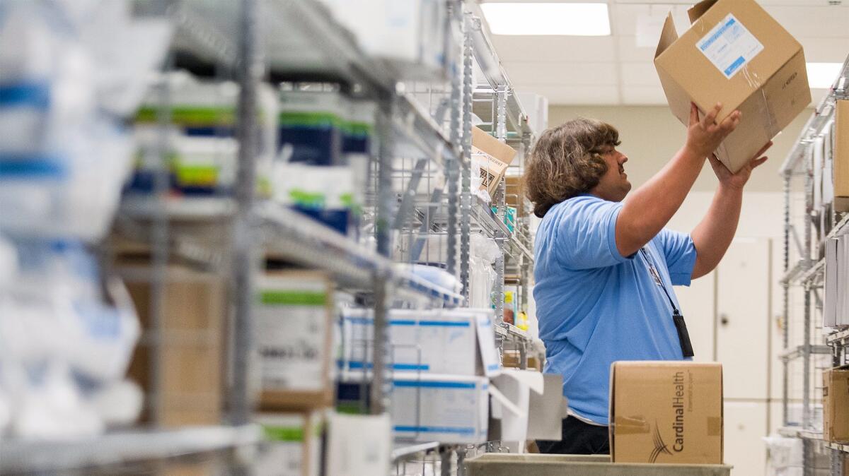 Samuel Weber, 21, stocks shelves at Hoag Hospital in Newport Beach. He is a student in the Seamless Transition Enrichment Program, or STEP, the Newport-Mesa Unified School District’s program to help special-education adults transition from school to jobs.