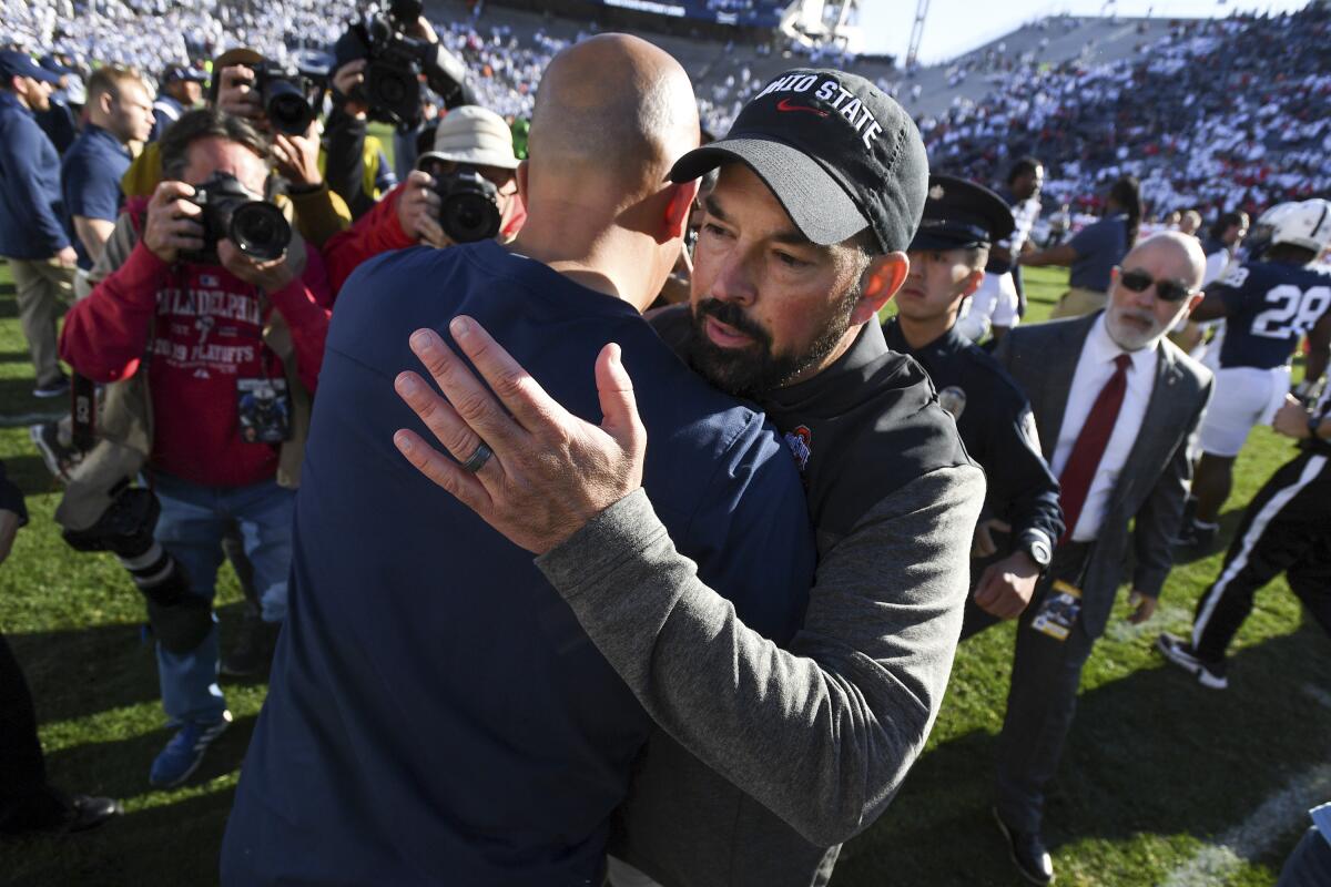 Ohio State head coach Ryan Day, right, greets Penn State head coach James Franklin following an NCAA college football game, Saturday, Oct. 29, 2022, in State College, Pa. Ohio State won 44-31. (AP Photo/Barry Reeger)