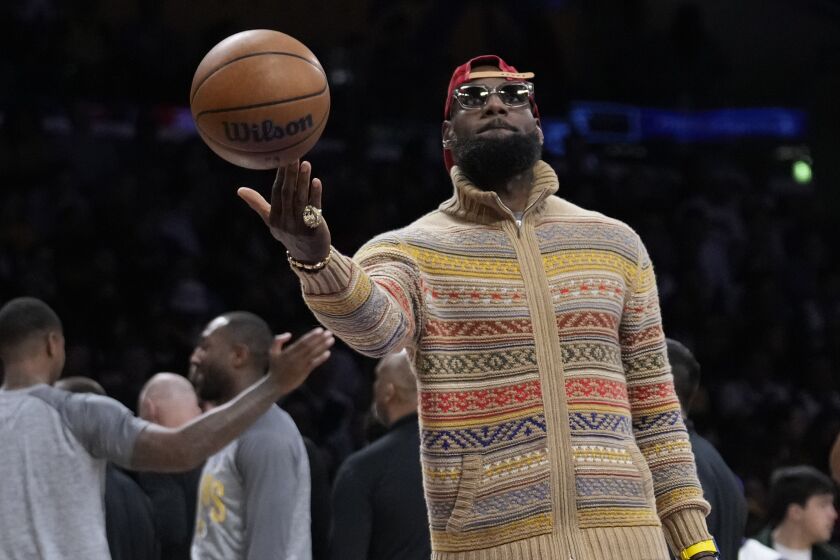 Los Angeles Lakers forward LeBron James holds a basketball during a timeout 