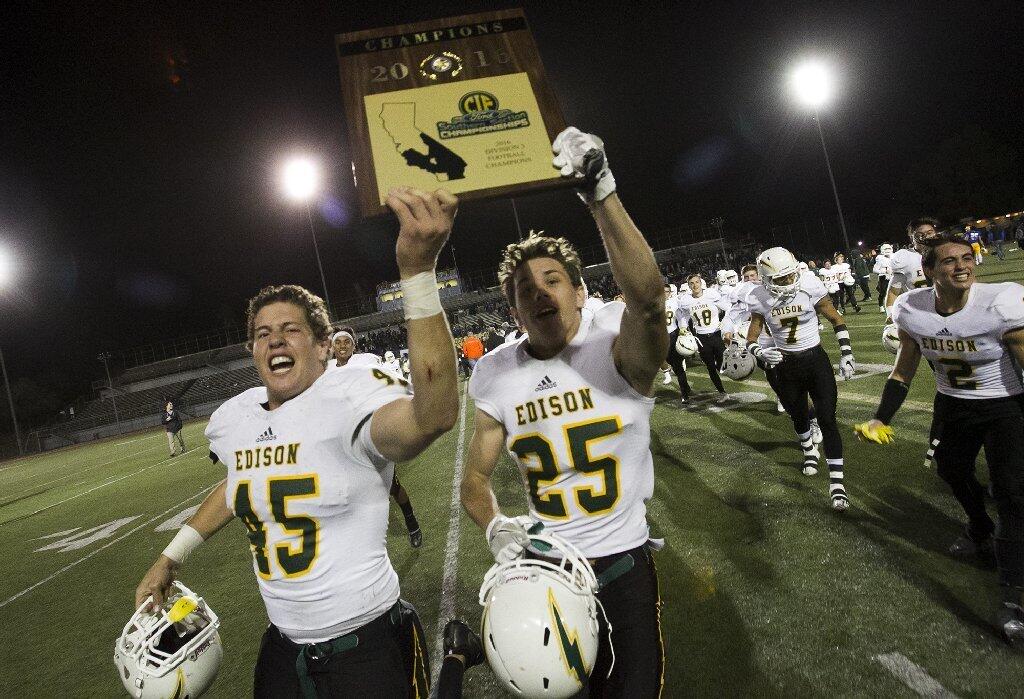Edison's Kenny Carmichael, left, and Shaun Colamonico celebrate after beating La Mirada 44-24 in the CIF Southern Section Division 3 championship game on Friday.
