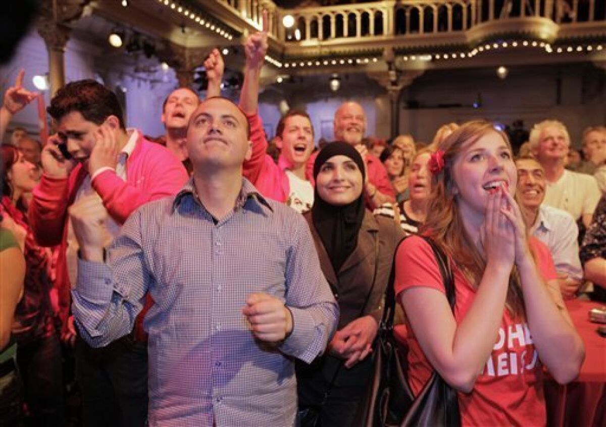 Supporters of the Labor party react as the first preliminary results are announced in Amsterdam, Netherlands, Wednesday June 9, 2010. Preliminary exit polls in the Dutch elections Wednesday showed the pro-business VVD party and Labor party are likely to finish in a dead heat as the largest parties, dealing a blow to the ruling Christian Democrats and giving an anti-Islam party its best showing ever. (AP Photo/Peter Dejong)