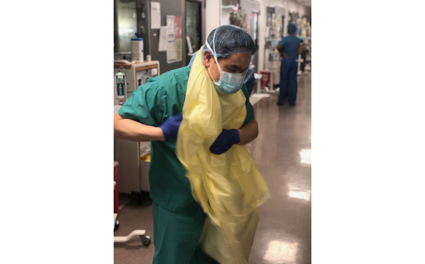 Dr. Glen Chun dons his personal protective equipment