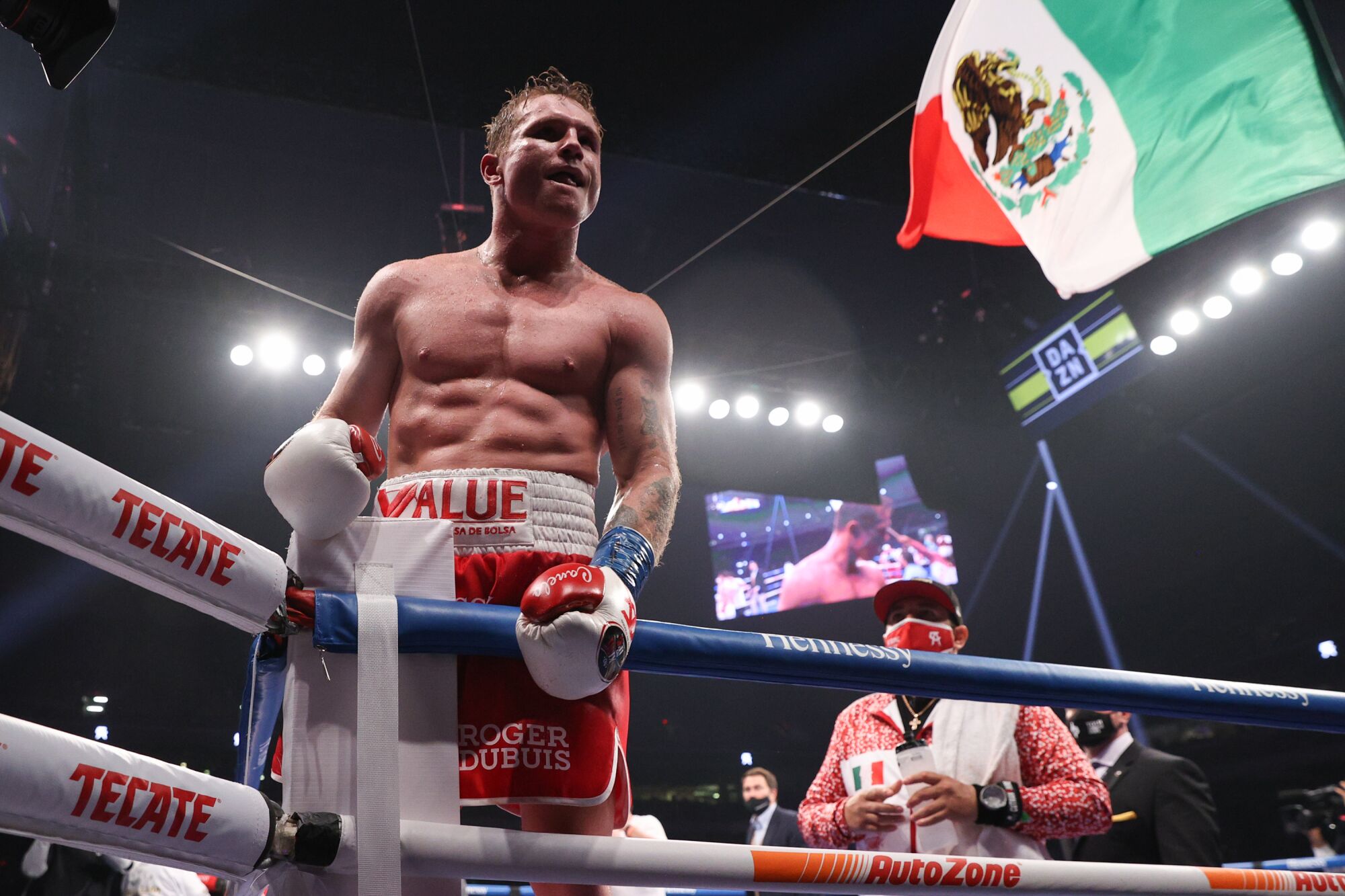 Canelo Alvarez celebrates after defeating Callum Smith by unanimous decision in a championship title fight.