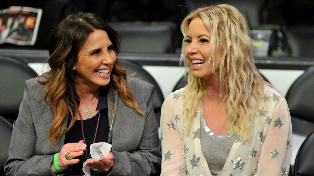 Lakers team executive Linda Rambis, left, and Jeanie Buss talk during a game at Staples Center in March.