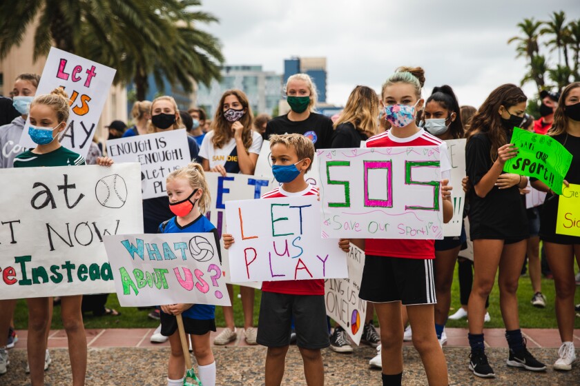 Children rally in front of the County Administration Center to demand to be allowed to play sports on Oct. 10, 2020.