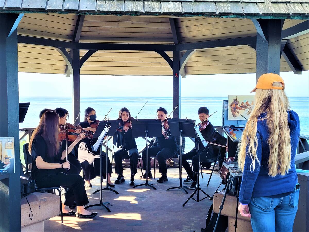 A Laguna Plein Air Painters Assn. artist captures musicians at Heisler Park during the 2023 Laguna Beach Music Festival.