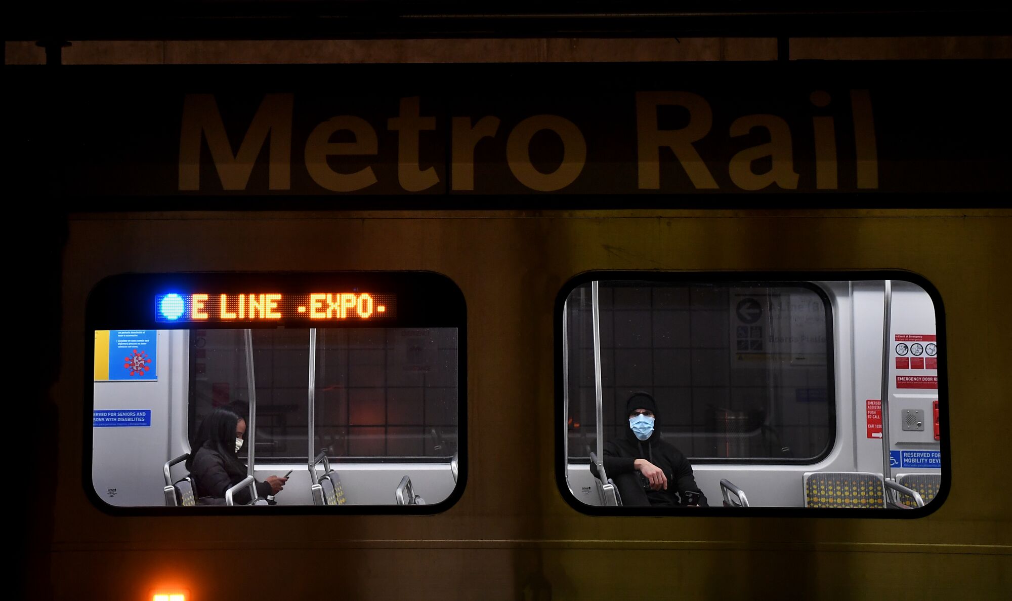 Passengers wear masks on a Metro train in downtown Los Angeles.