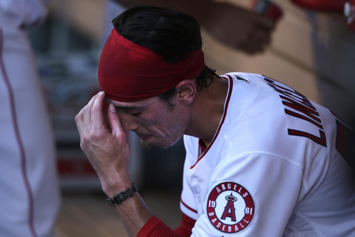 Angels pitcher Tim Lincecum catches his breath in the dugout after giving up three runs to the Astros in the first inning.