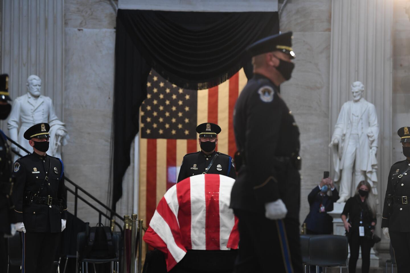 Members of the U.S. Capitol Police honor guard stand near the flag-draped casket of Rep. John Lewis, D-Ga., on Monday in the Rotunda of the U.S. Capitol in Washington.