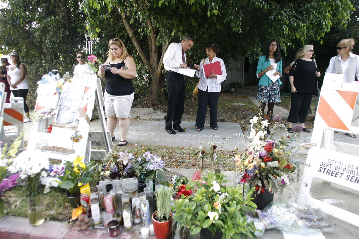 Families and friends of the victims of last week's electrocution accident attend a press conference where the accident happened on Ben Ave. and Magnolia Blvd. in Valley Village on August 22, 2012.