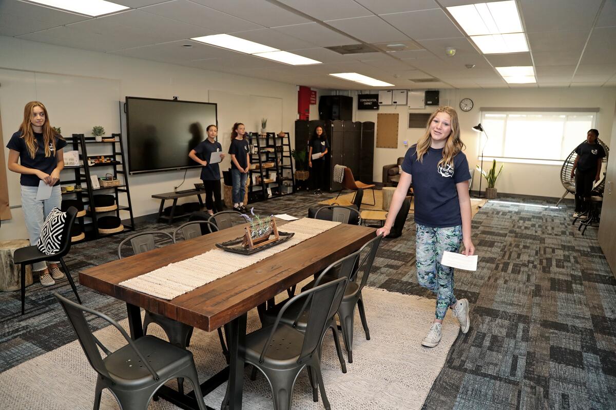 Seventh-grader Jaylen Maroney, at a table, speaks at a tour of the Student WellSpace at Marine View Middle School.