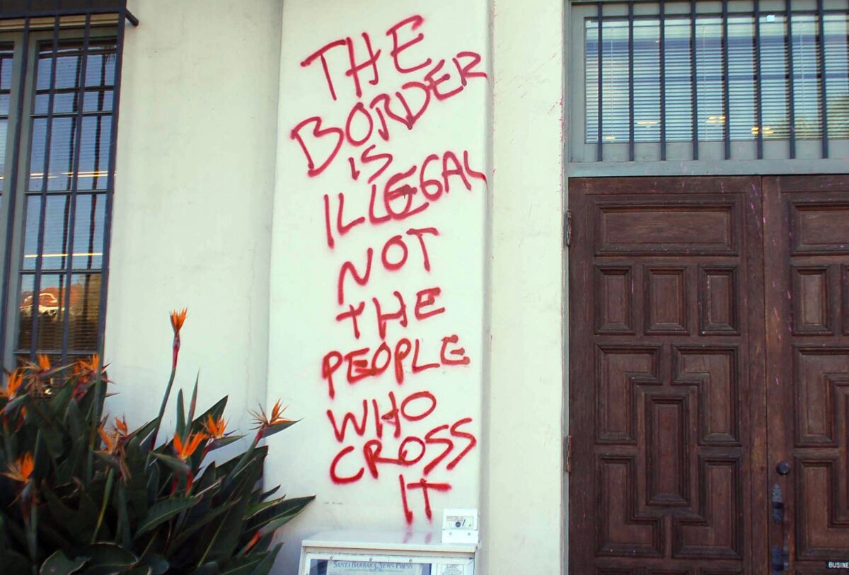 Graffiti is splattered on the entrance to the Santa Barbara News-Press building in Santa Barbara.