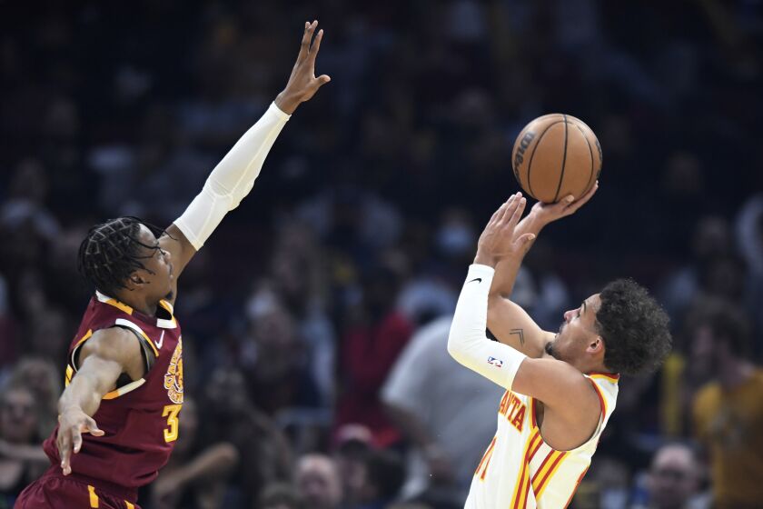 The Atlanta Hawks' Trae Young shoots against the Cleveland Cavaliers' Isaac Okoro on April 15, 2022.