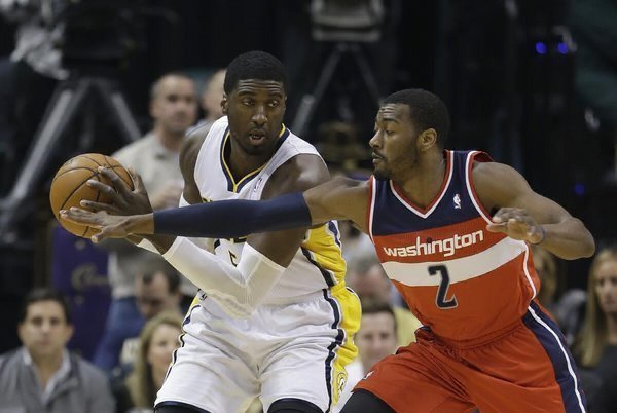 Indiana center Roy Hibbert is defended by Washington guard John Wall on Nov. 29. Hibbert and the Pacers lead the Eastern Conference with a record of 15-1 before heading into their Sunday matchup with the Clippers at Staples Center.